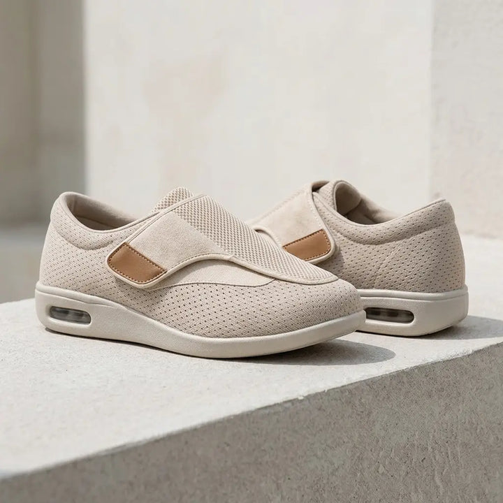 Beige mesh slip-on, wide hook-and-loop strap, tan trim, air-cushion heel