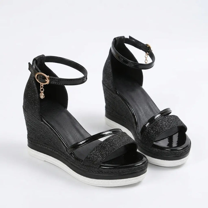 Black glitter wedge sandals with patent strap, ankle strap and braided espadrille wedge, angled pair view