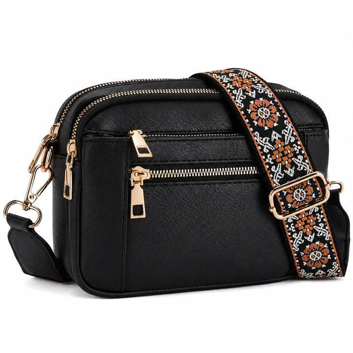 Camera crossbody bag with wide woven jacquard shoulder strap in geometric floral pattern