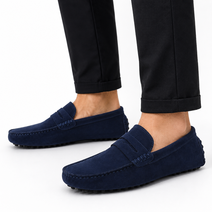 Men's suede penny loafers showing penny keeper strap and pebble rubber outsole