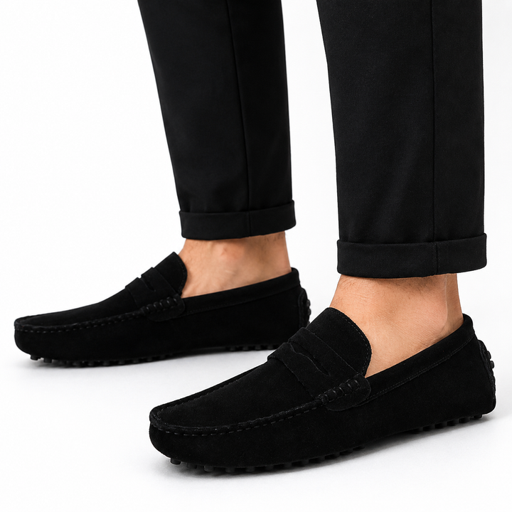 Men's suede penny loafers showing tan leather lining and rubber outsole detail