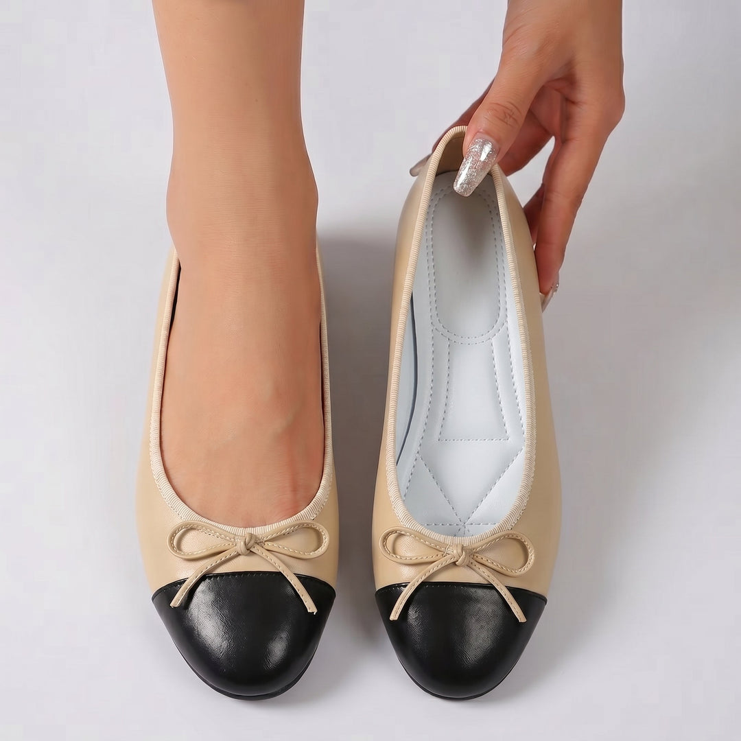 Women's camel ballet flats with black toe cap and bow, flat sole, interior view
