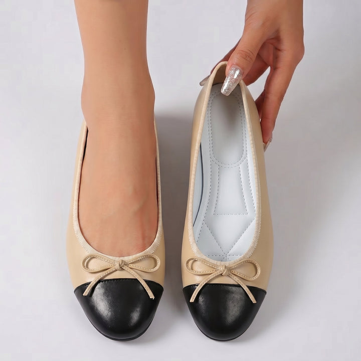Women's camel ballet flats with black toe cap and bow, flat sole, interior view