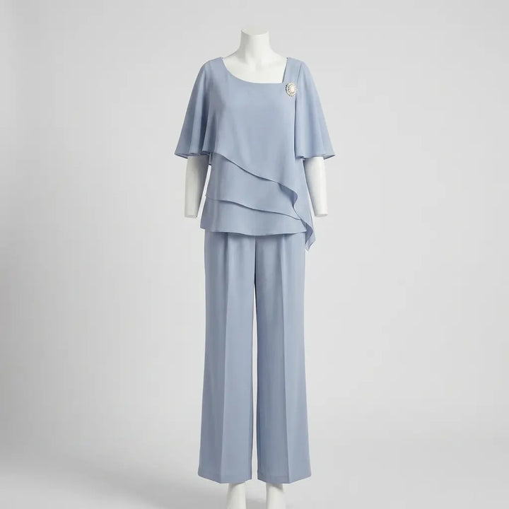 Light blue asymmetric layered top and straight-leg trousers on mannequin, front view