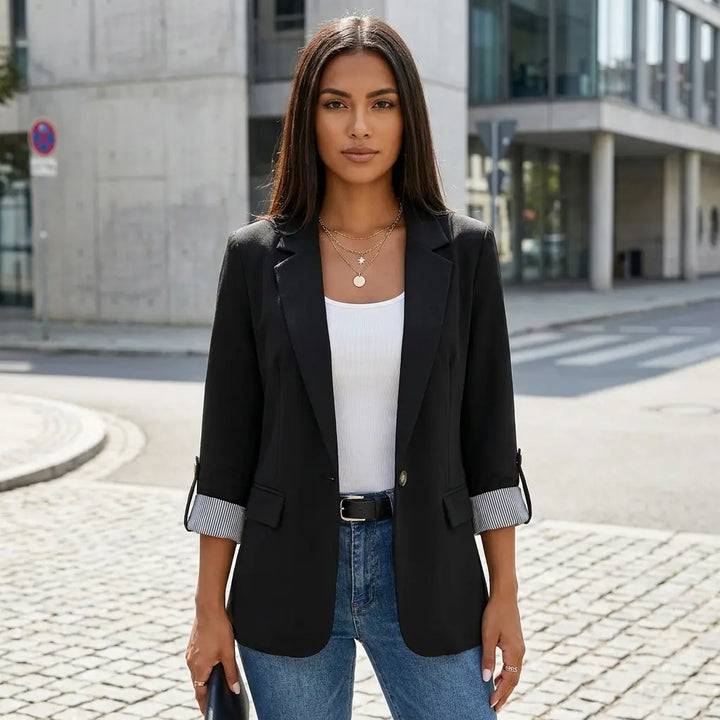 Women's 3/4 sleeve blazer in black with notched lapel, styled with blue jeans