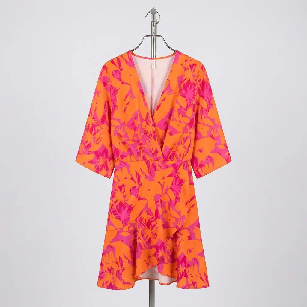 Mini wrap dress with batwing sleeves in orange and pink tropical print on stand