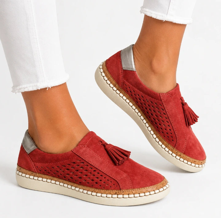 Side view of women's slip-on shoe showing whipstitch border and cork midsole band