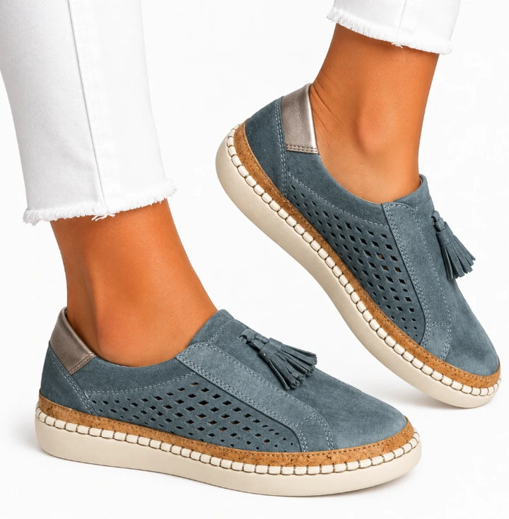 Top view of women's casual slip-on shoe showing round-toe silhouette and laser-cut perforations