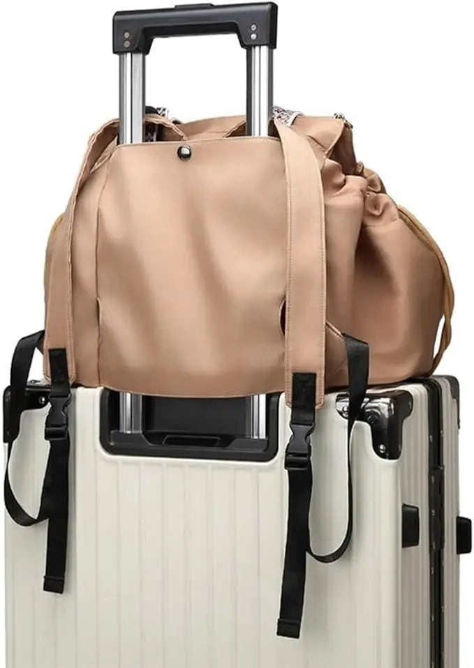 Tan travel tote strapped over a suitcase trolley handle, back view