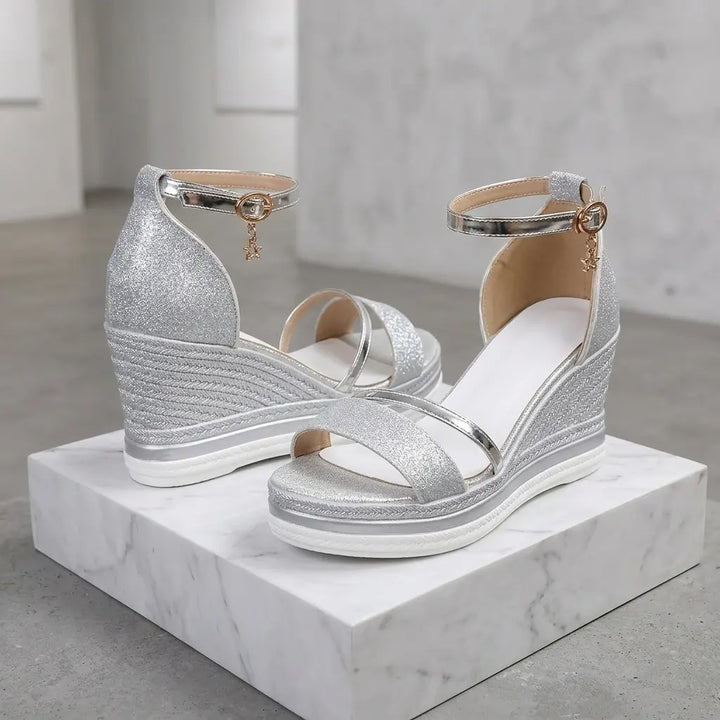 Silver glitter wedge sandals with star charm and white platform sole, side pair view