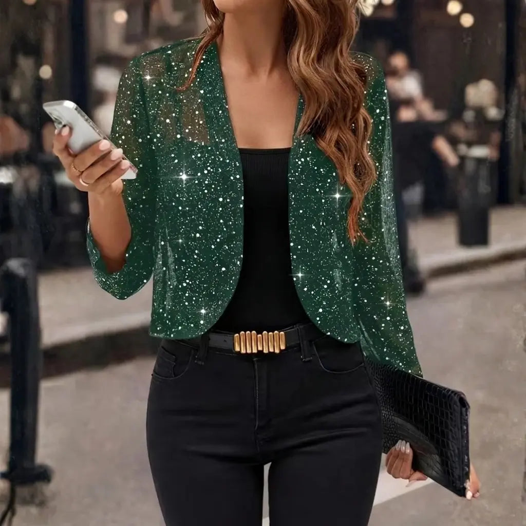 Women's green sequin open-front jacket styled with clutch bag, evening look