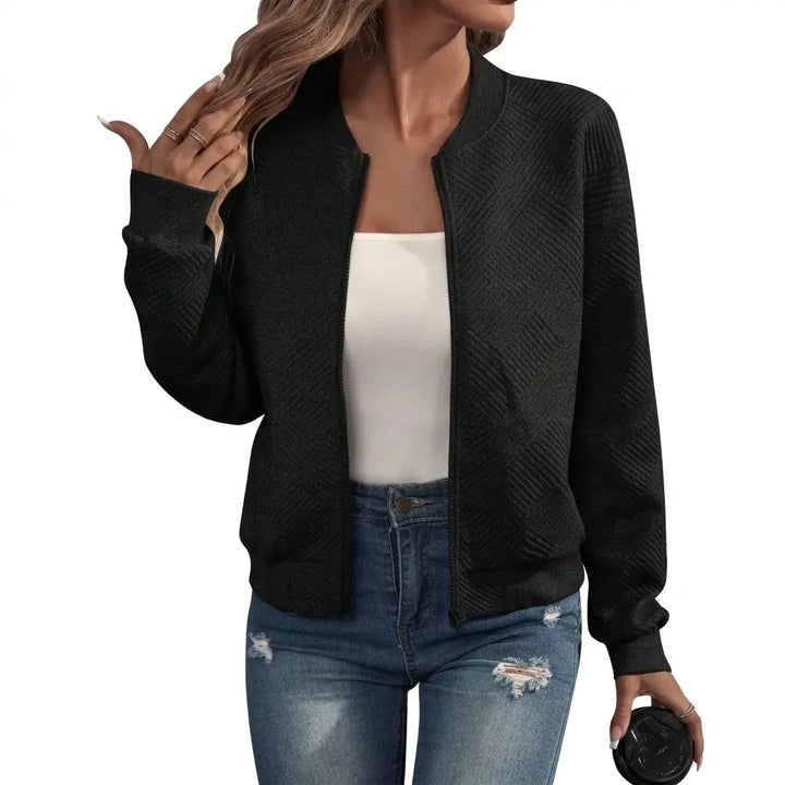 Black quilted bomber jacket with zip front and ribbed cuffs, front view