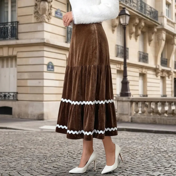 Brown velvet tiered midi skirt worn by model, side angle