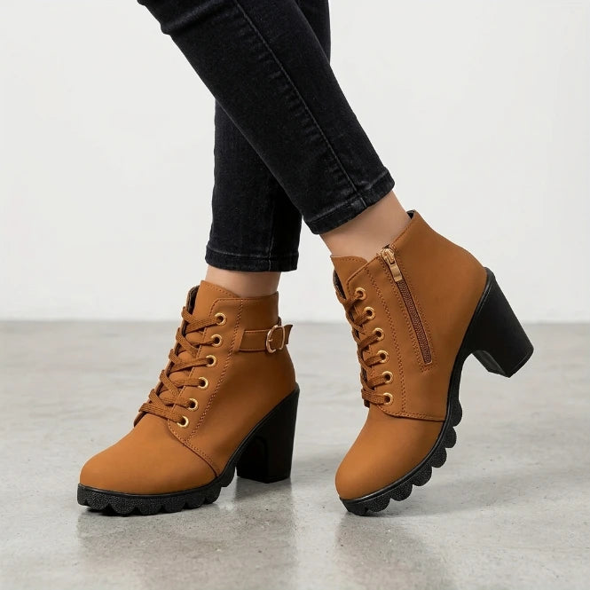 Pair of black women's lace-up ankle boots with block heel