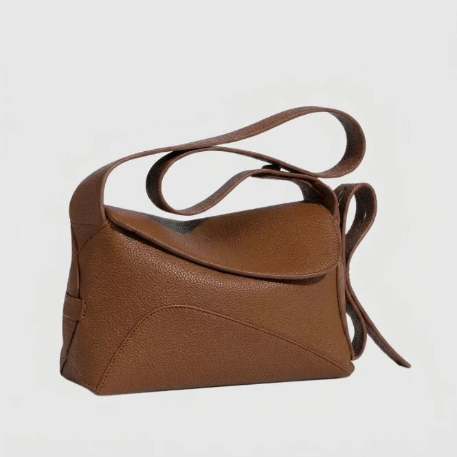 Structured crossbody bag with pebbled texture and adjustable strap, flat lay