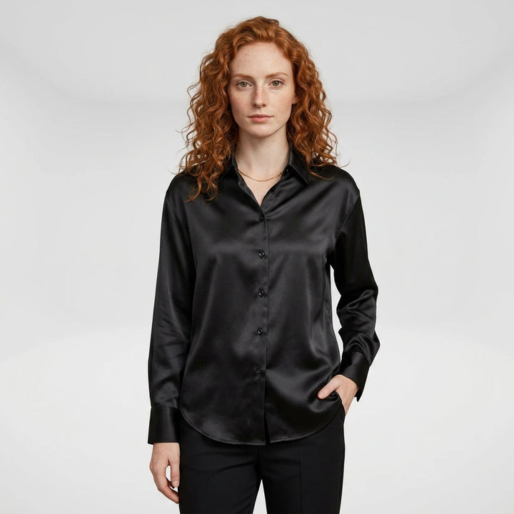 Women's black satin button-up blouse with long sleeves, model front view