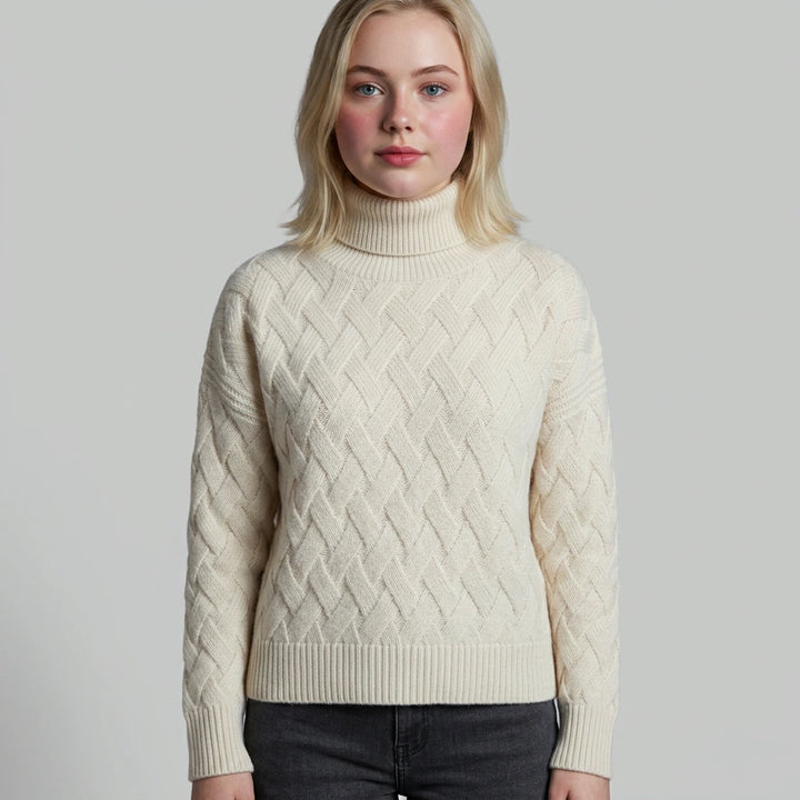 Turtleneck sweater detail — fold-over collar and knit cuffs in beige