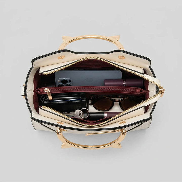 Flat lay of women's cat ear handbag — top view showing full exterior and removable strap