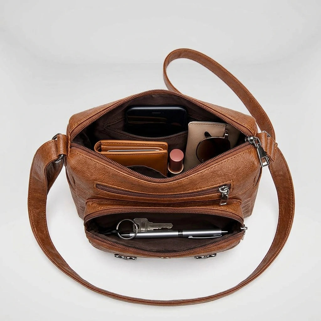 Brown structured shoulder bag flat lay with adjustable strap detail