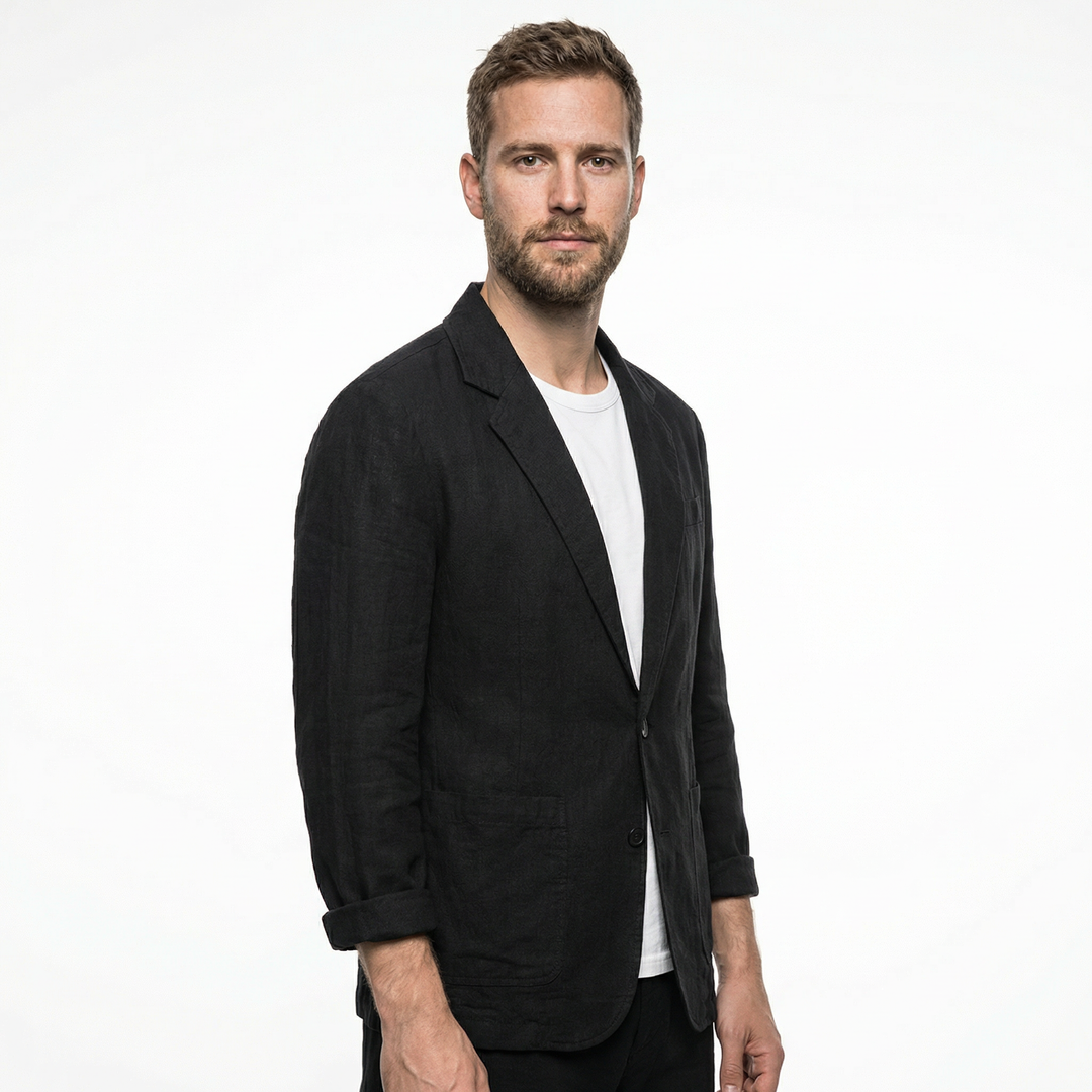 Detail view of collar and button closure on men's black linen blazer