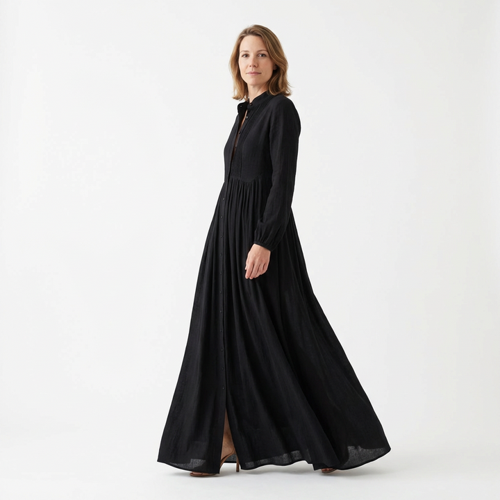 Black maxi dress with stand collar and flowing A-line skirt in motion, three-quarter view