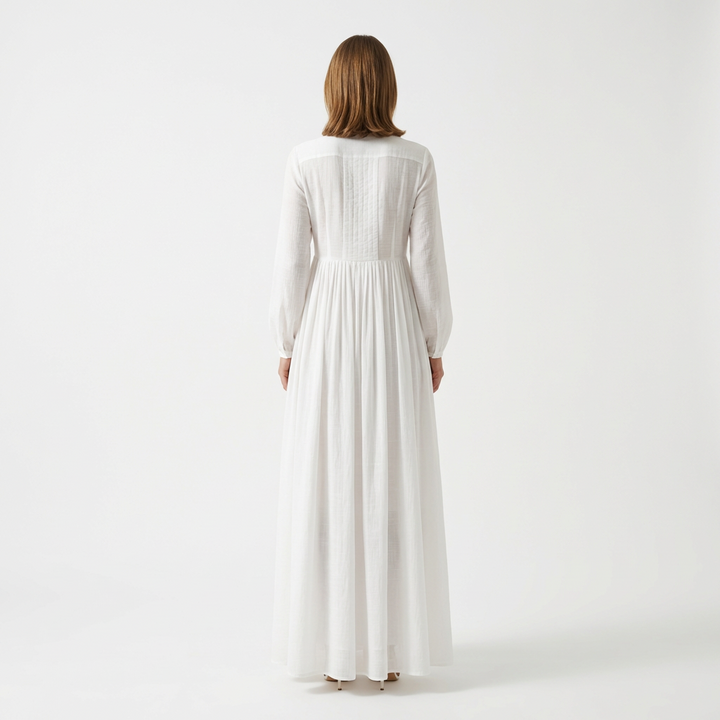 White maxi dress back view with pintuck bodice and flowing A-line skirt