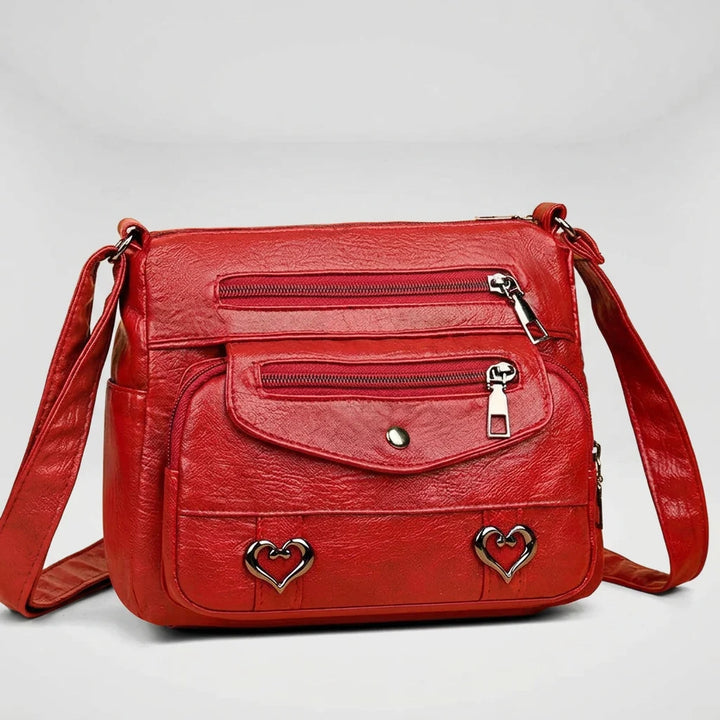 Women's structured shoulder bag in red with gold hardware, front view