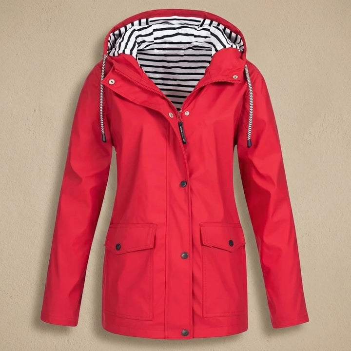 Interior lining of pink waterproof jacket showing taped seams and inner zip pocket