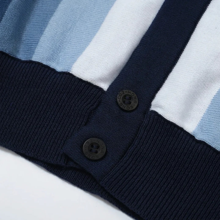 Detail close-up of button placket and ribbed hem on striped knit polo