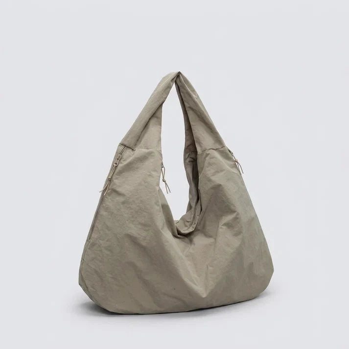 Nylon hobo bag with shoulder strap and multiple pockets, side angle