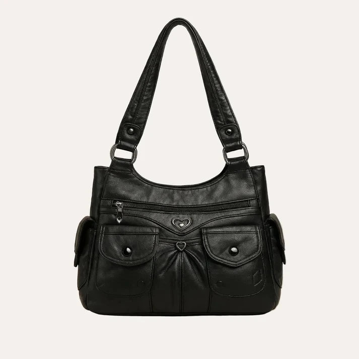 Heart-shaped hardware accent and zipper closure close-up