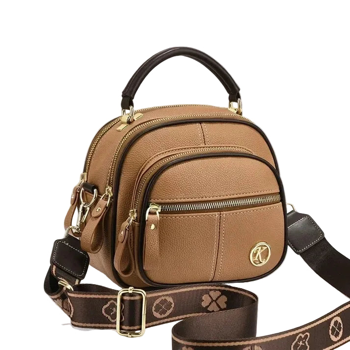 Tan pebbled leather crossbody bag with top handle and detachable patterned strap