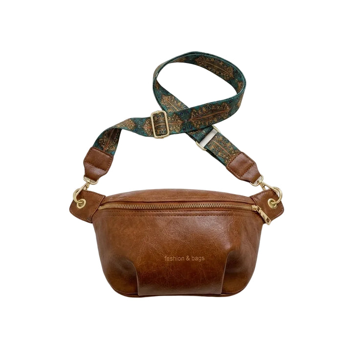 Women's leather belt bag with embroidered boho strap, flat lay