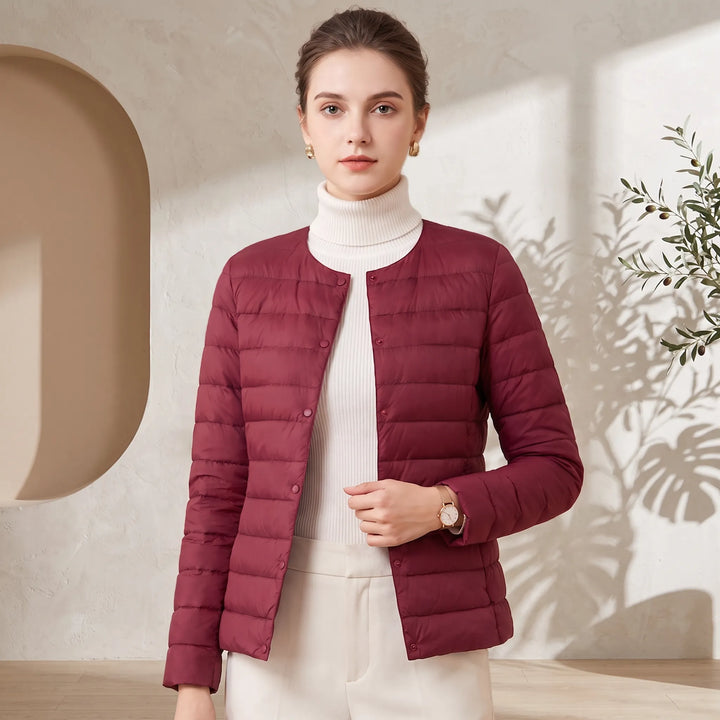 Slim-fit quilted down jacket collarless round neck front view