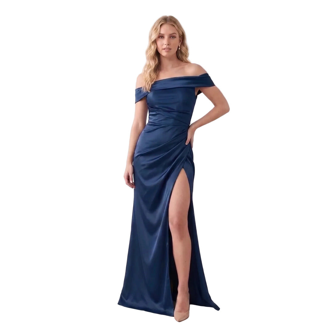 A woman modeling a navy blue off-the-shoulder satin maxi dress with a high thigh slit, photographed against a clean white studio background.
