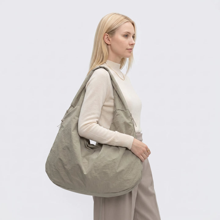Large nylon shoulder bag with zipper pocket, flat lay detail