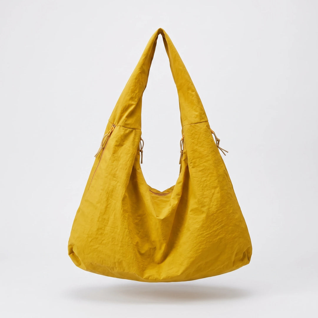 Nylon hobo bag showing laptop compartment capacity, flat lay