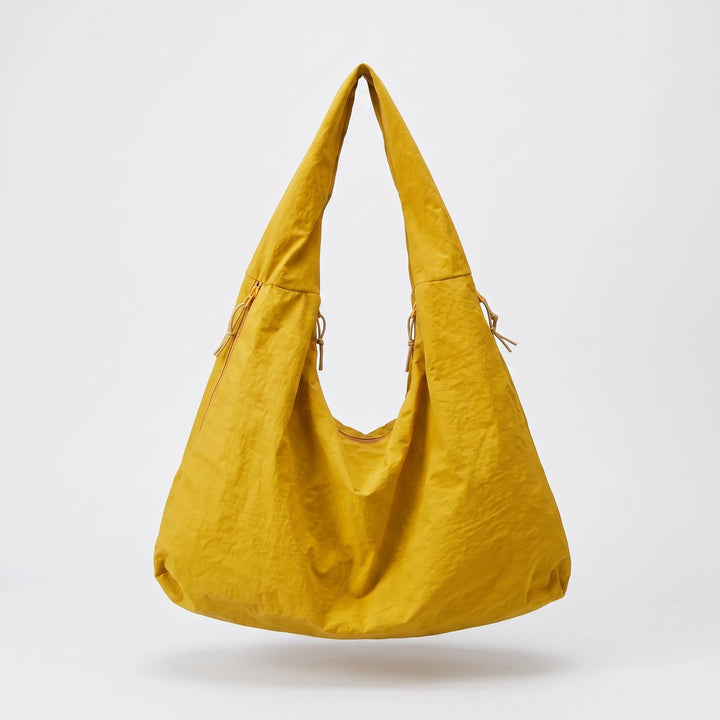 Nylon hobo bag showing laptop compartment capacity, flat lay
