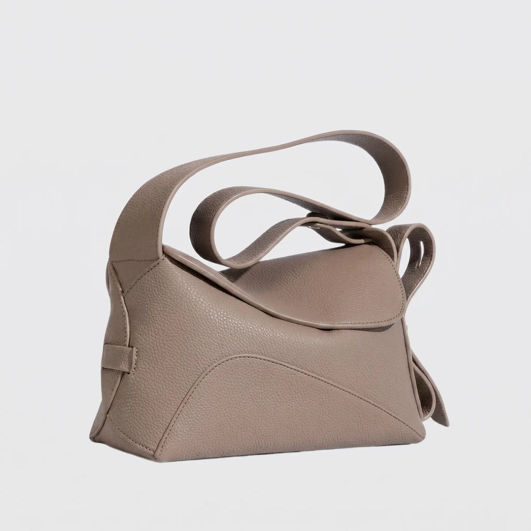 Compact structured crossbody bag with magnetic flap closure, flat lay