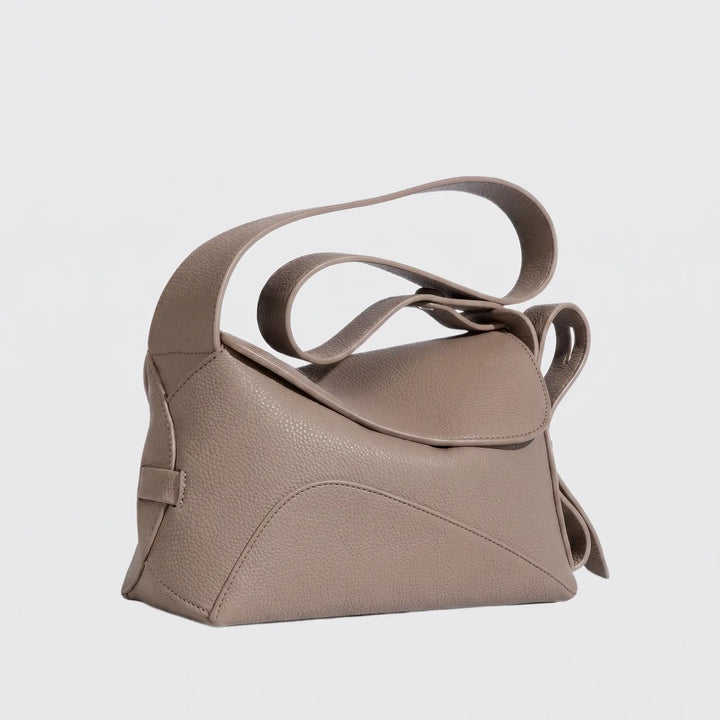 Compact structured crossbody bag with magnetic flap closure, flat lay