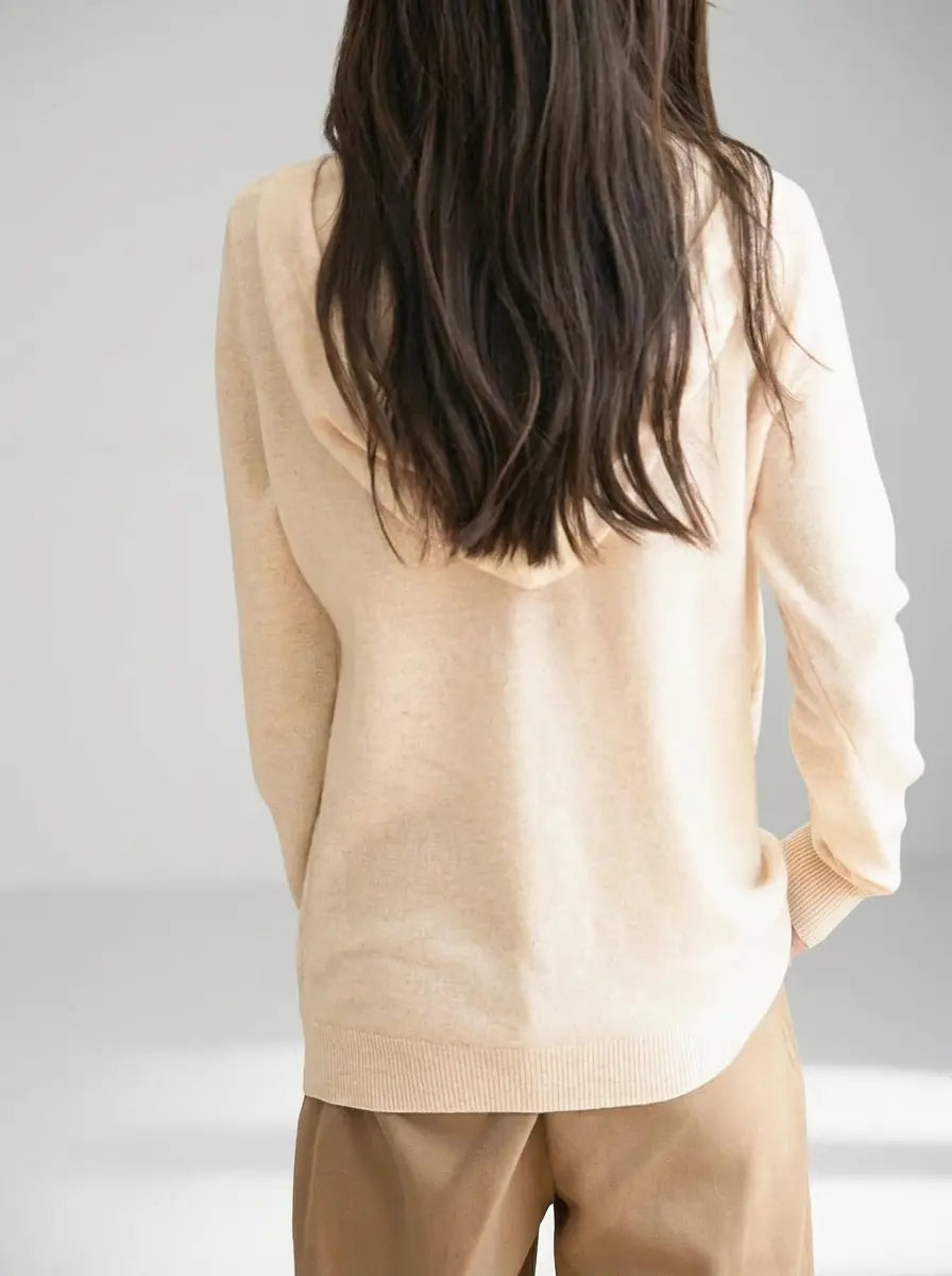 Women's knit zip-up hoodie in beige showing clean back and ribbed hem
