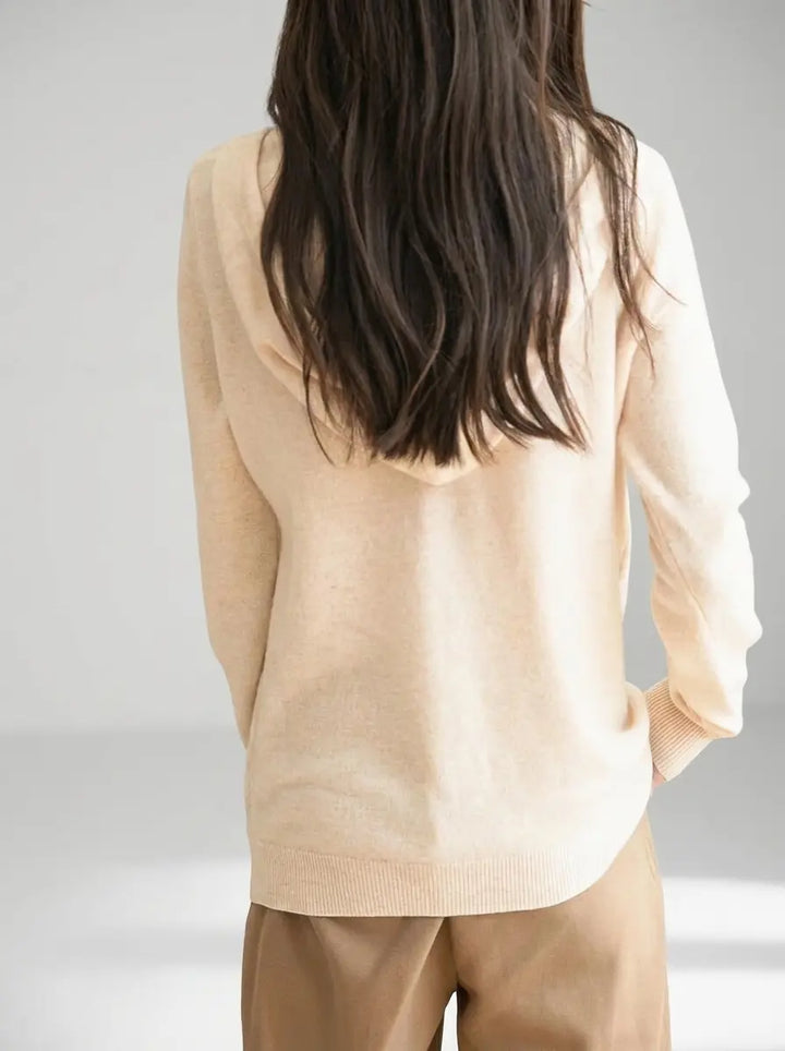 Women's knit zip-up hoodie in beige showing clean back and ribbed hem