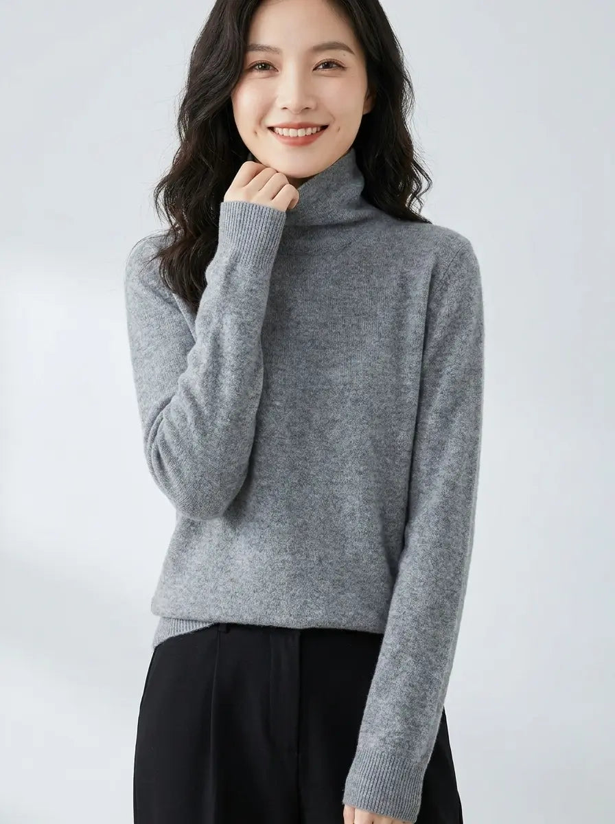 Light grey turtleneck knit sweater with long sleeves, three-quarter view
