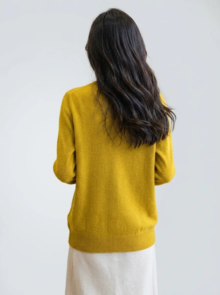Mustard yellow turtleneck knit sweater showing ribbed hem, back view