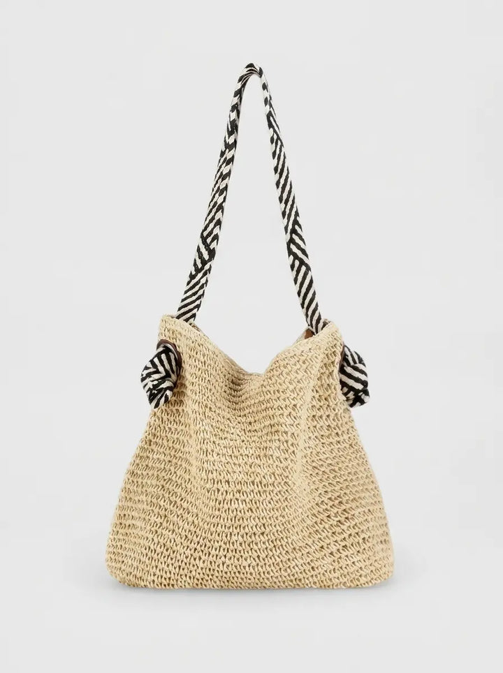 Woven shoulder bag in natural beige with striped fabric strap, flat lay