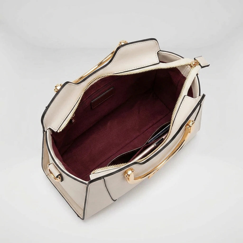 Interior of black cat handle handbag — 4 pockets including main zip, secondary zip, phone slot and ID window