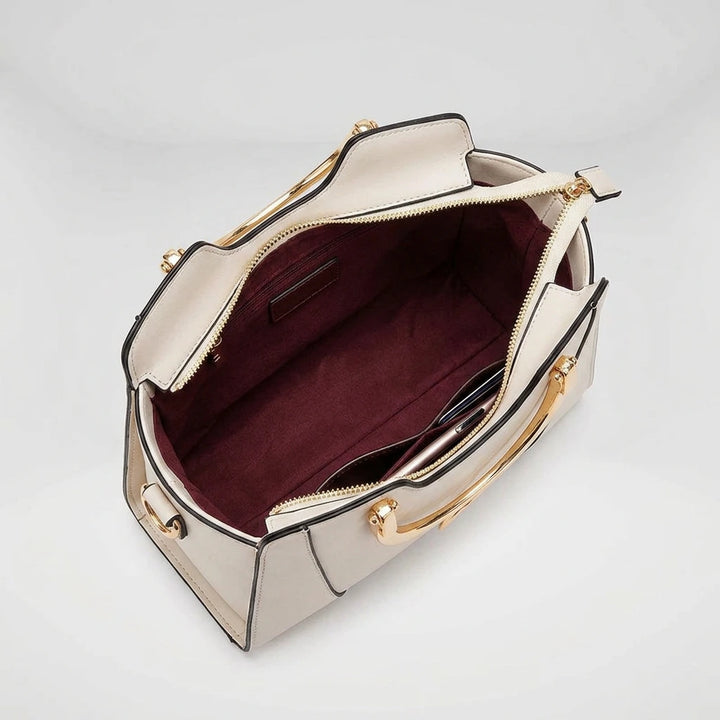 Interior of black cat handle handbag — 4 pockets including main zip, secondary zip, phone slot and ID window