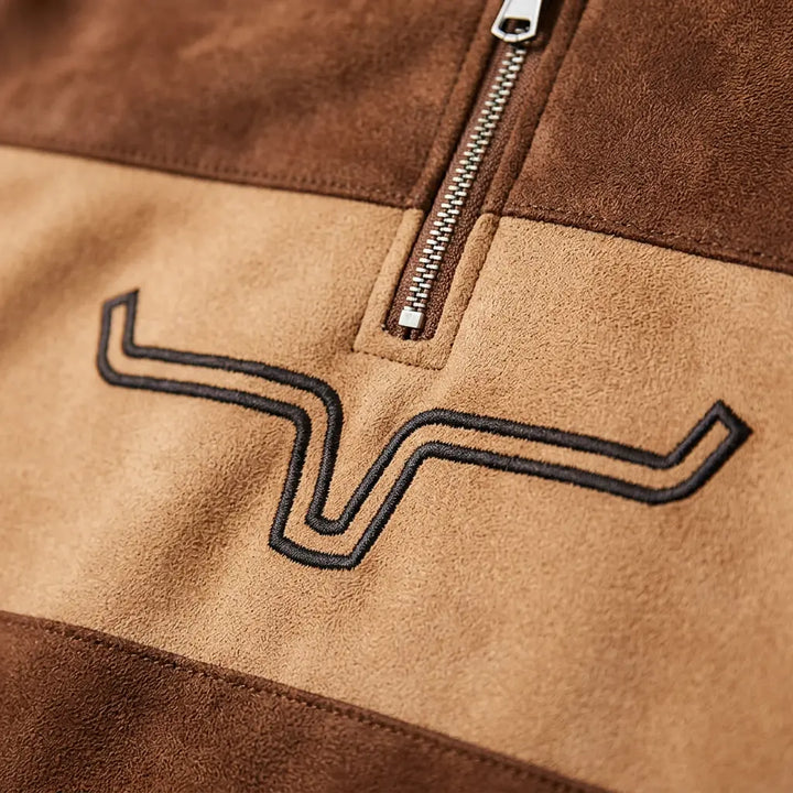 Embroidered longhorn chest motif and silver quarter-zip hardware close-up detail