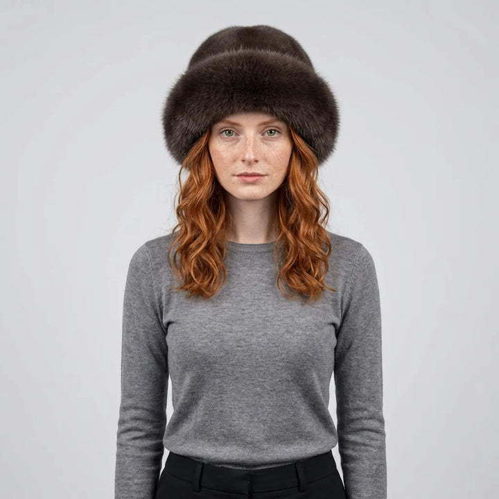 Woman wearing dark brown faux fur winter hat, front view