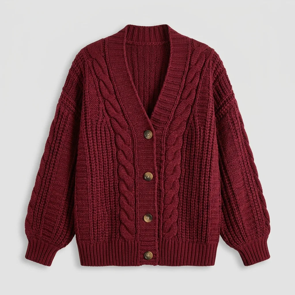 Women's oversized cardigan flat lay close-up showing cable knit texture